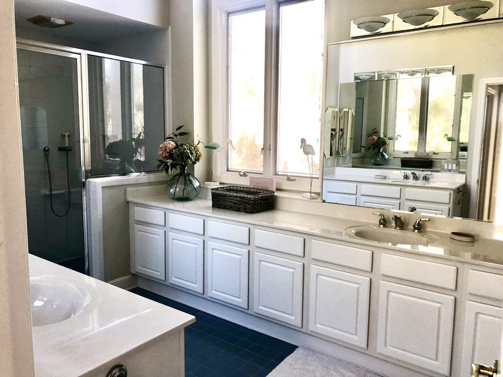 Master bathroom with 'her" separate vanity, walk-in tile shower, separate toilet room